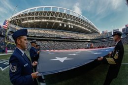 people in the military keep the American banner during ceremonies before a-game between your Seattle Seahawks and Detroit Lions final thirty days.