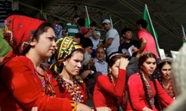 Wearing the original twin braids, female college pupils, wearing Uzbek clothing, attend the once a week rushing event.